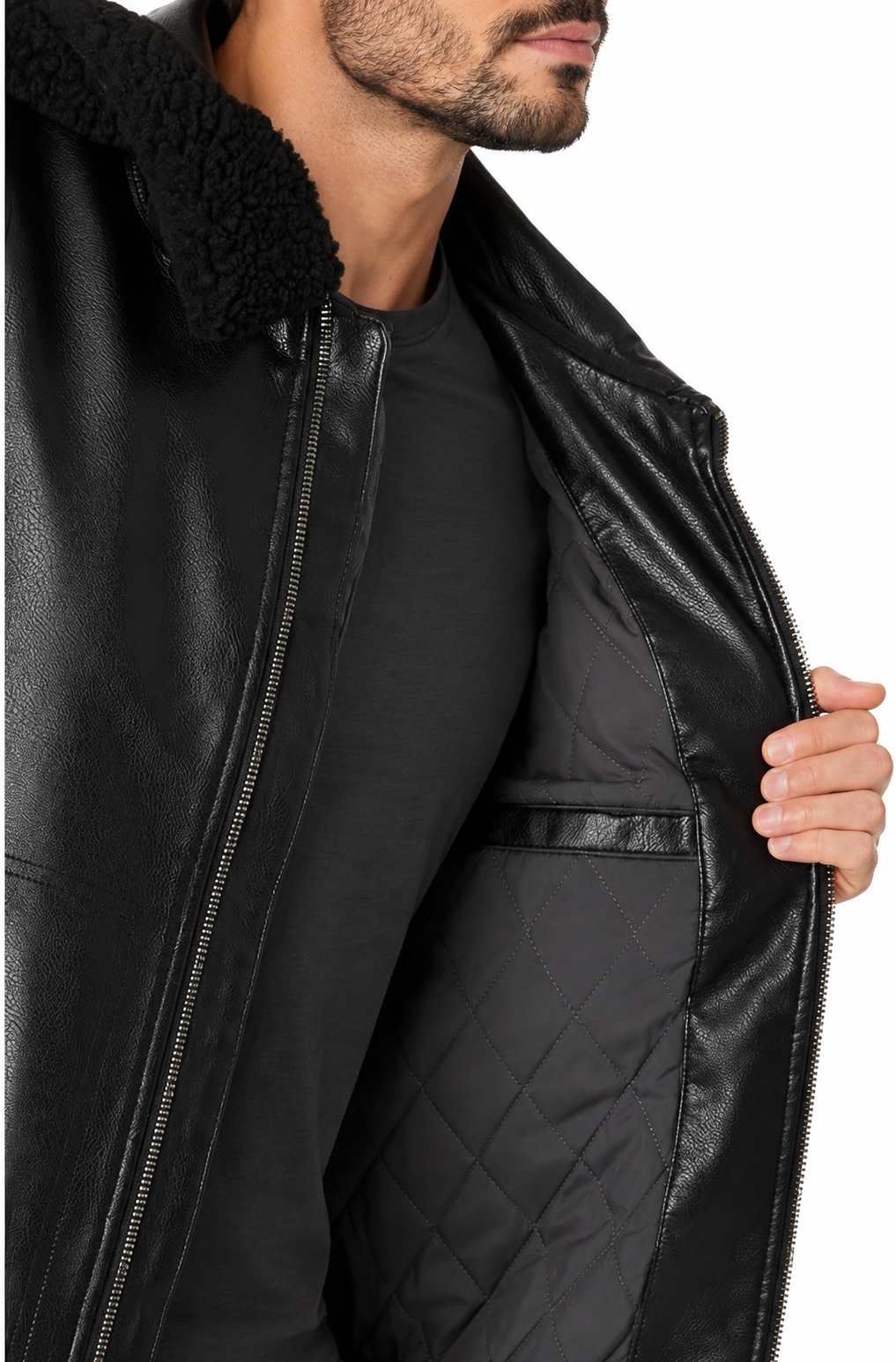 Close-up of a man wearing a black real-leather jacket with a black sherpa collar, opening the front zipper to reveal a black quilted lining.